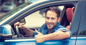 Man in a car giving a thumbs up